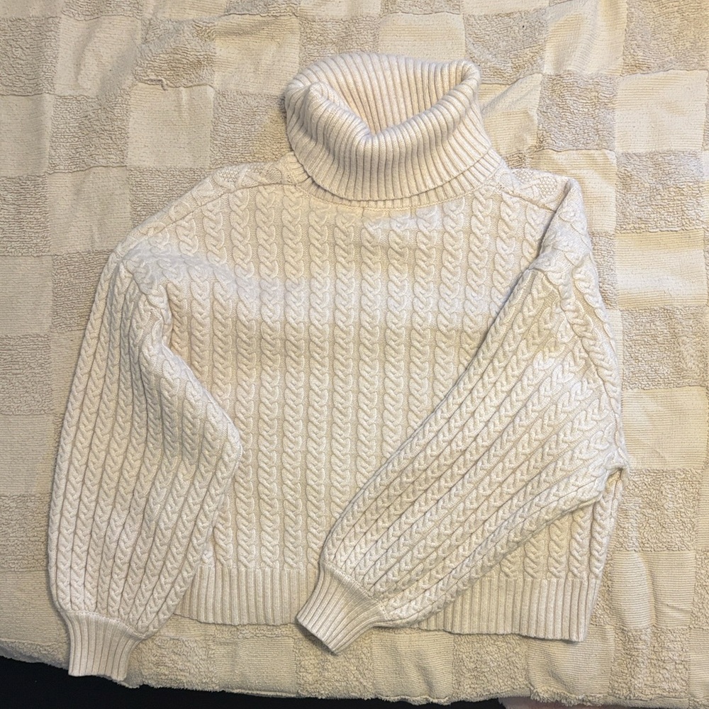 White turtleneck sweater.